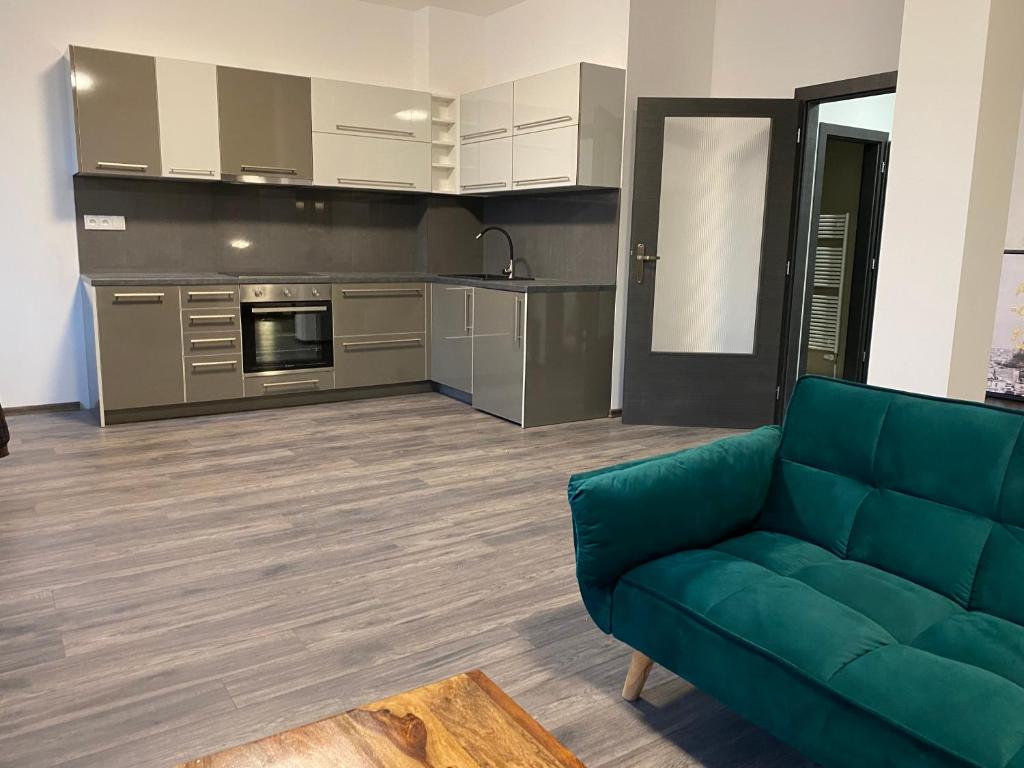 a living room with a couch and a kitchen at Boutique Apartments Liberec in Liberec
