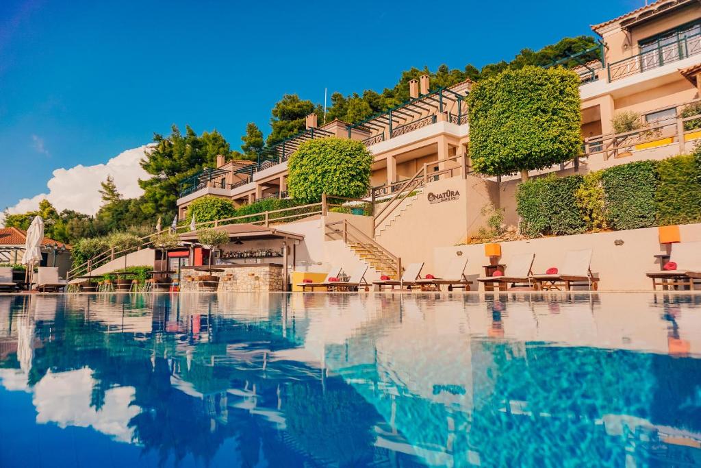 a view of a pool of water in front of a building at Natura Club Hotel & Spa - Adults Only in Kyparissia