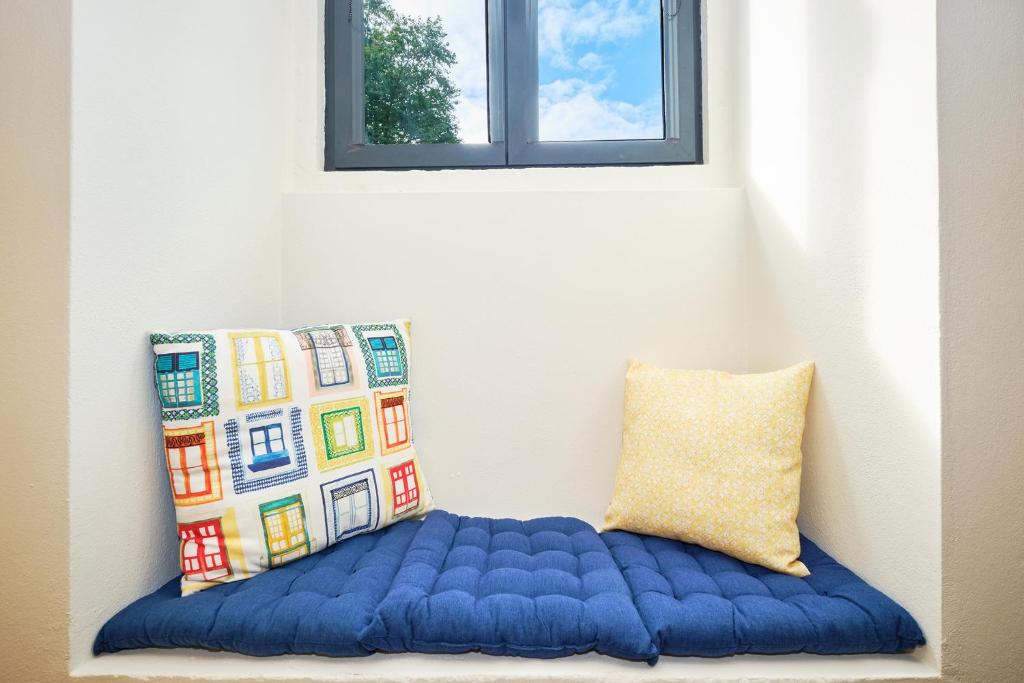 a blue pillow sitting next to a window at Sintra Bliss A Part in Sintra