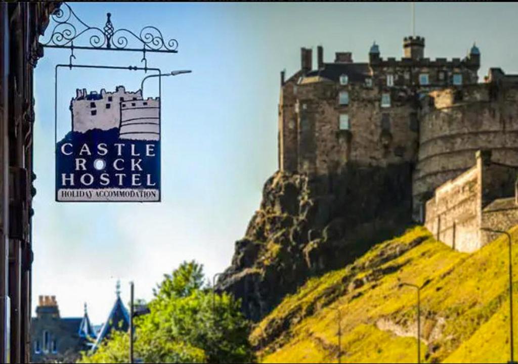 a castle rock hospital sign in front of a castle at Castle Rock Hostel in Edinburgh