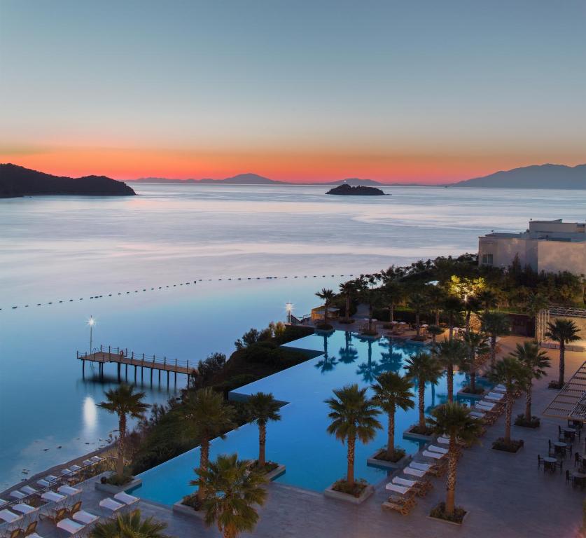 an aerial view of a resort with palm trees and the ocean at Xanadu Island in Akyarlar