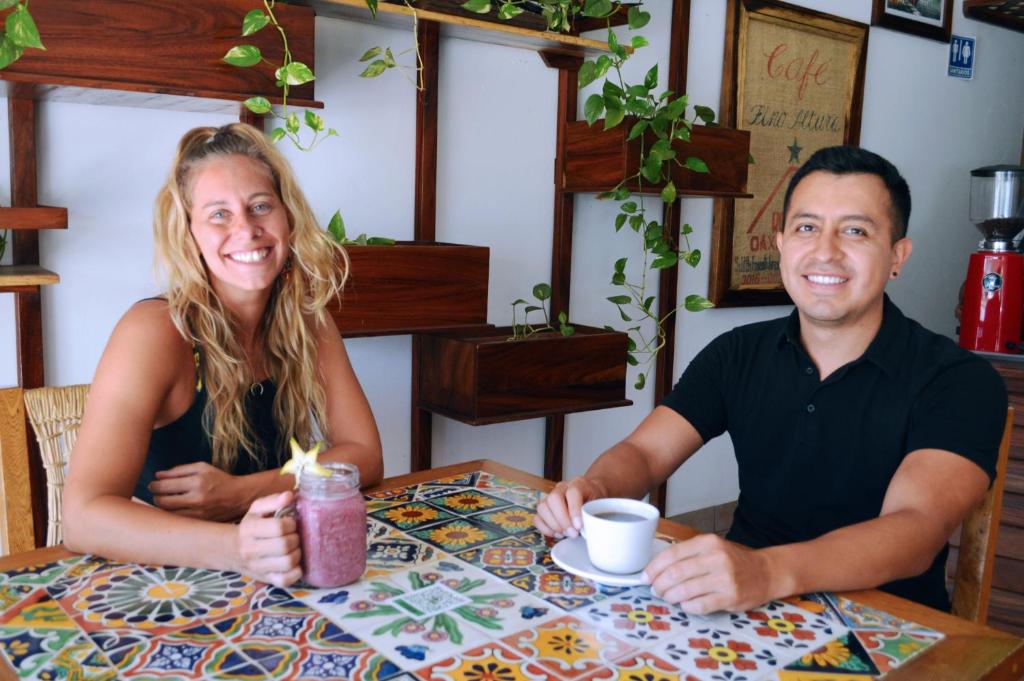 a man and a woman sitting at a table at Casa Losodeli & Coworking- Adults Only in Puerto Escondido