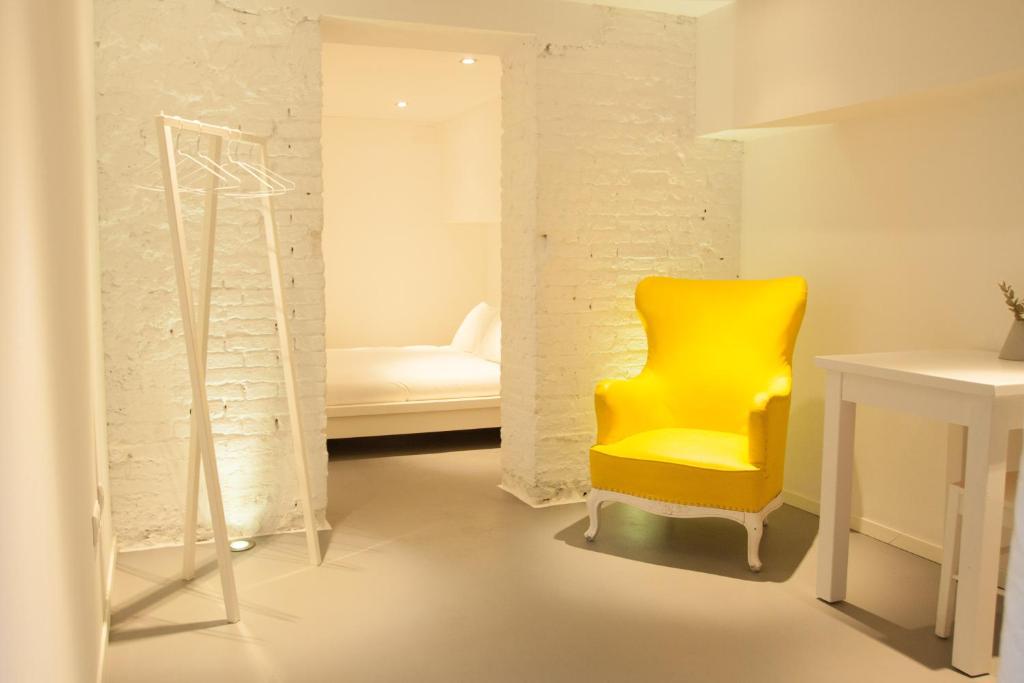 a yellow chair in a room with a desk at ABCyou Bed&Breakfast in Valencia