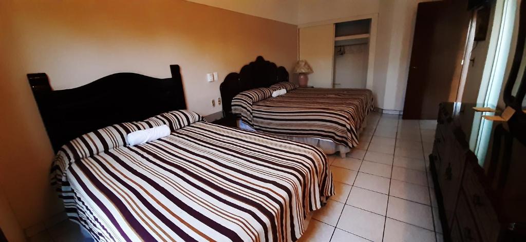 Postel nebo postele na pokoji v ubytování Hotel San Miguel