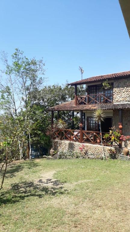 a large house with a porch on top of it at Casa Serra Negra in Bezerros