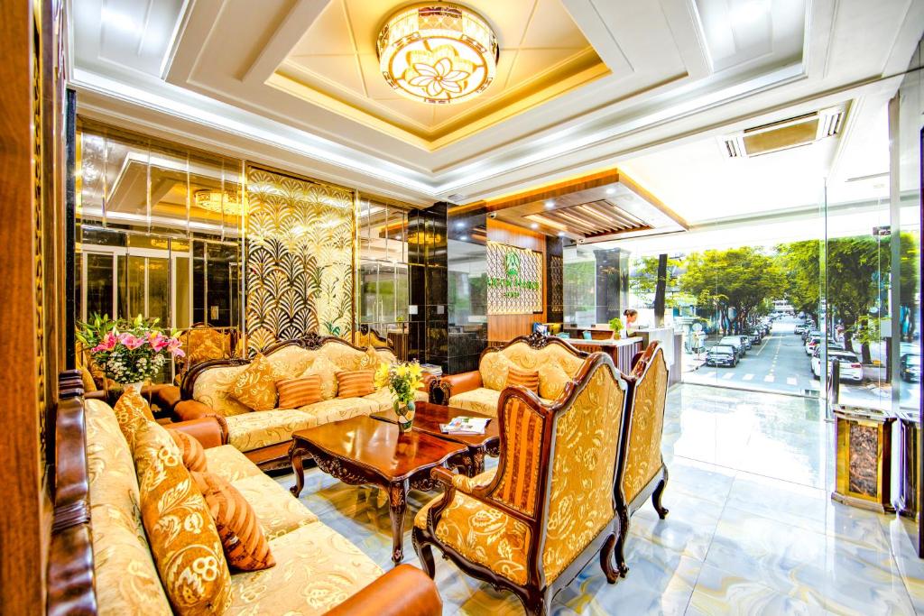 a living room with couches and a table at Saigon Hanoi Hotel in Ho Chi Minh City