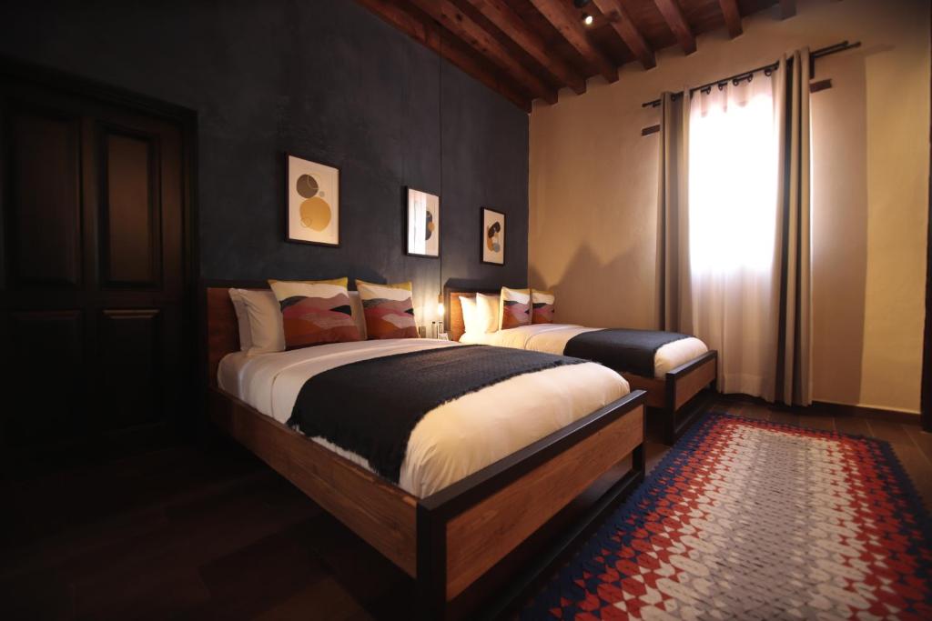 Postel nebo postele na pokoji v ubytování Antigua Trece Hotel Fusión