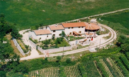 an aerial view of a house with a road around it at La Mandra in Morino