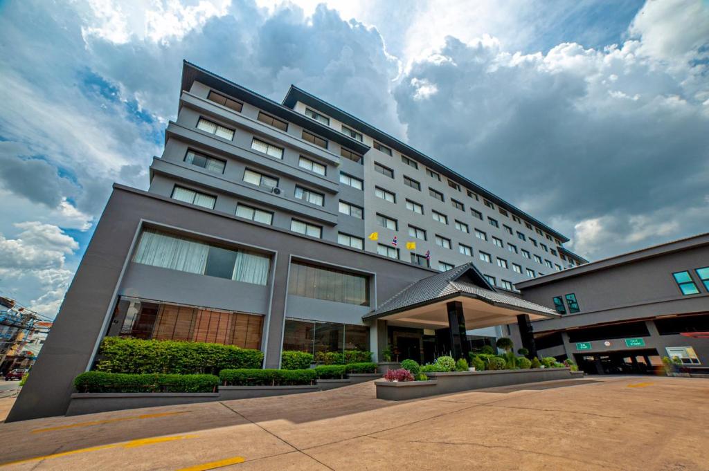 a large hotel building on a cloudy day at Le cassia Hotel in Khon Kaen