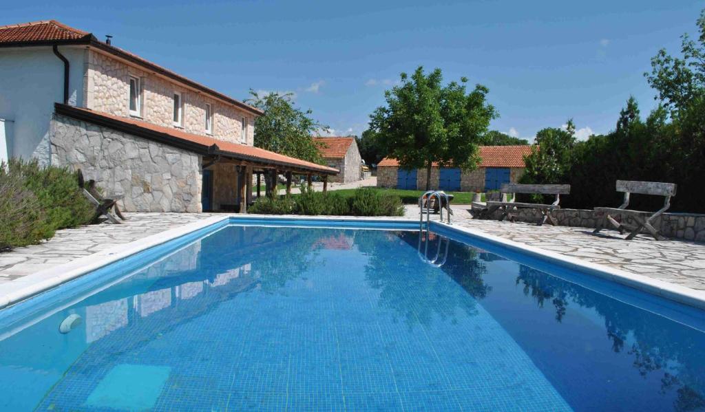 a swimming pool in front of a house at Country House Marića Gaj in Grude