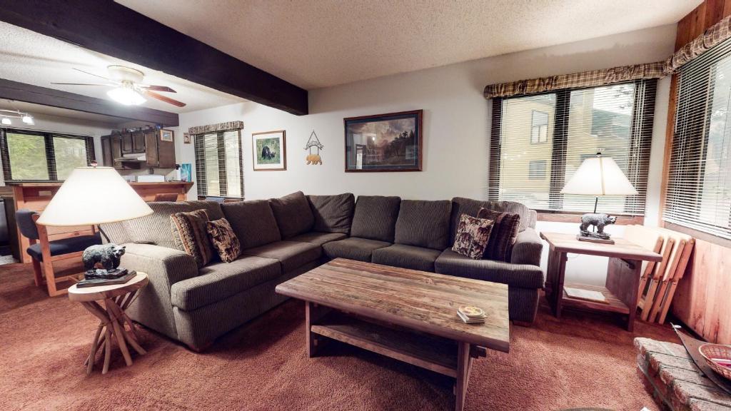 a living room with a couch and a coffee table at Wild Flower 37 Apartment in Mammoth Lakes