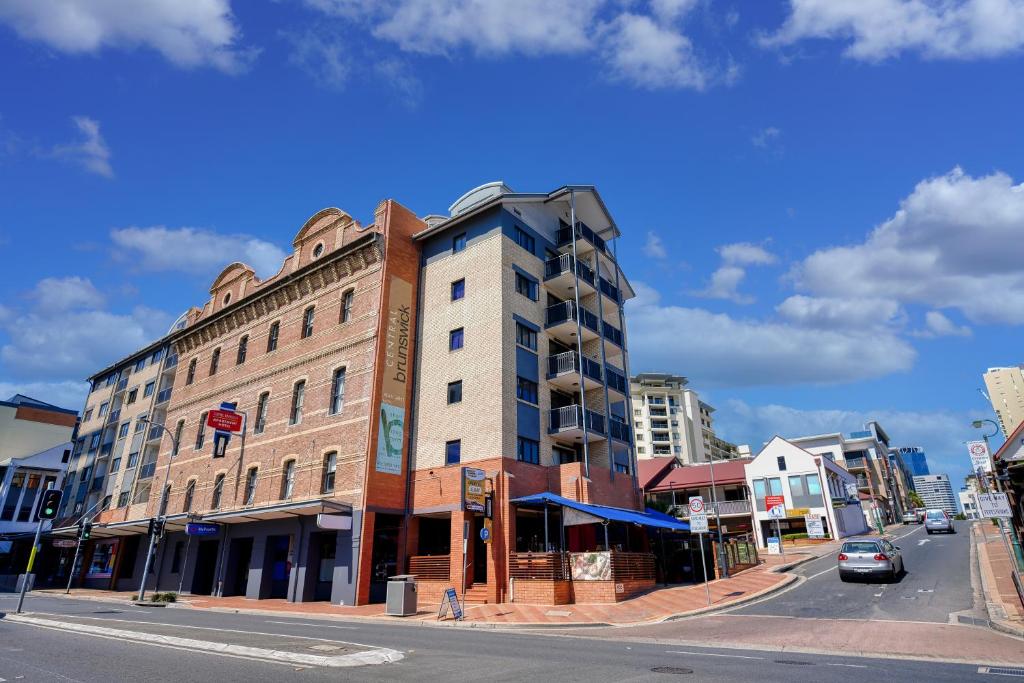 a building on the corner of a city street at Central Brunswick Apartment Hotel in Brisbane