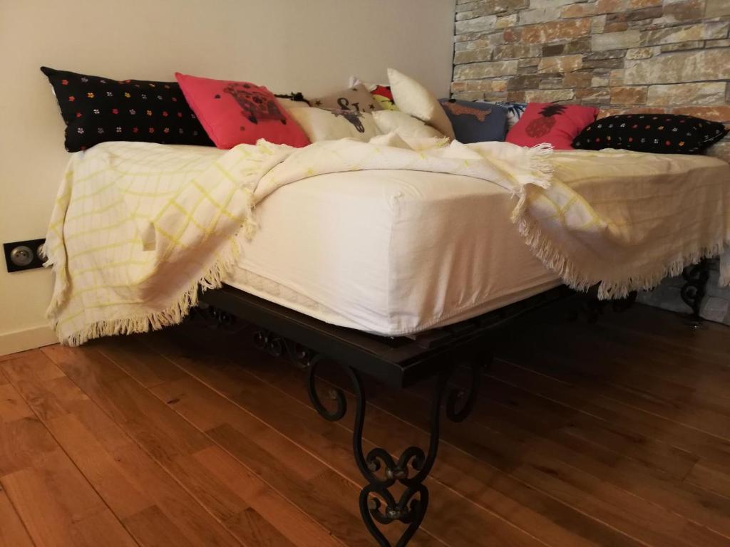 a bed with a white comforter and pillows at Maison Small Luxury ( planxa,suite,solarium,jacuzzi,pas de vis à vis) in Argelès-sur-Mer