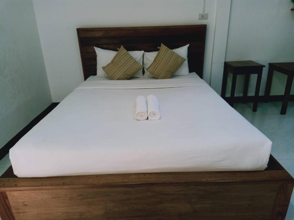 Postel nebo postele na pokoji v ubytování Rachawadee House