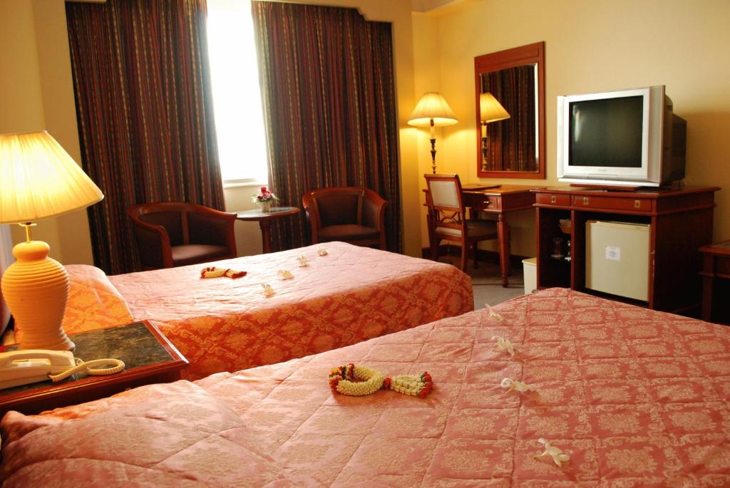 Postel nebo postele na pokoji v ubytování Charoen Thani Hotel, Khon Kaen