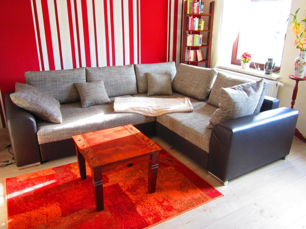 a living room with a couch and a coffee table at Hansis Lodge in Klingenthal