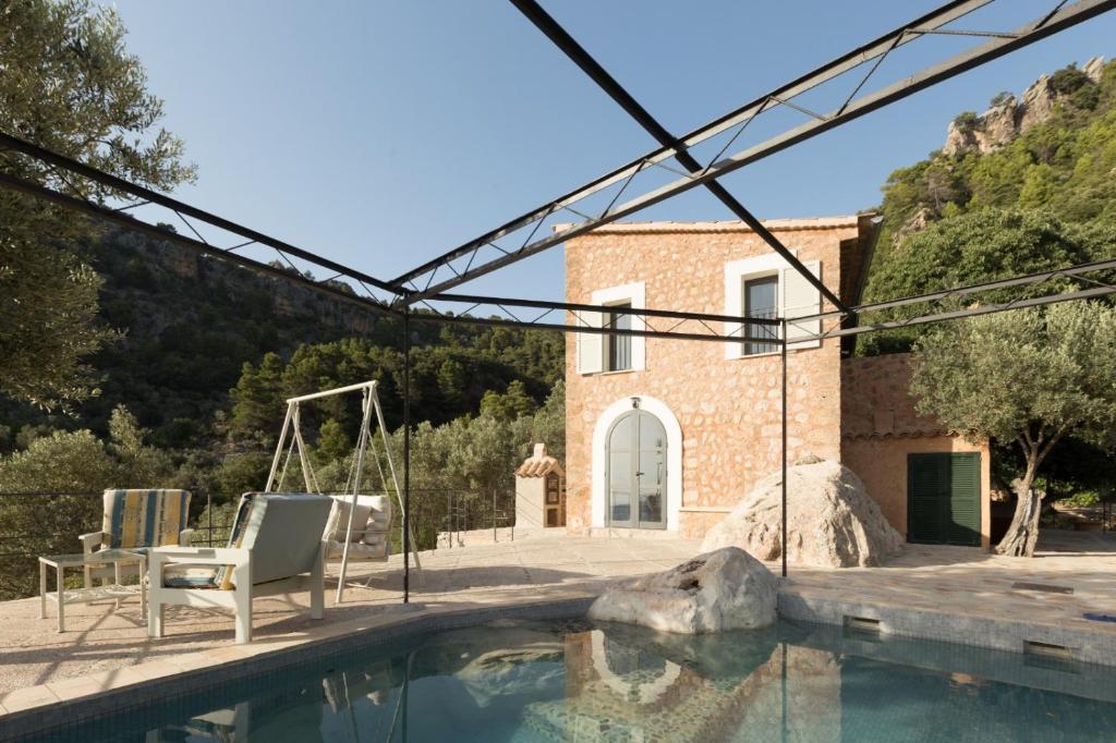 a villa with a swimming pool and a house at Can Estaràs in Fornalutx