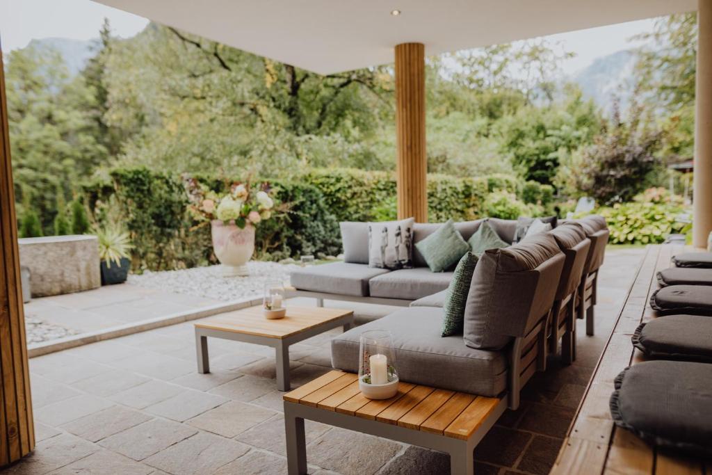 a patio with a couch and a table at Hotel Pass Lueg in Golling an der Salzach