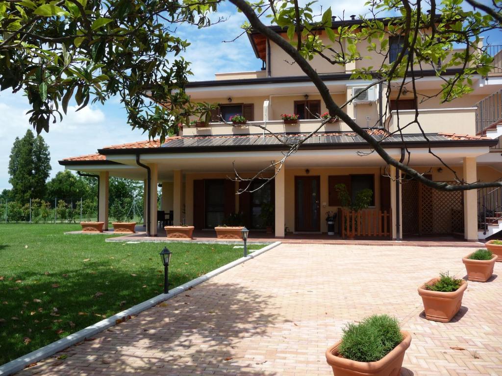 a building with potted plants in front of it at Villa Patrizia in San Canzian dʼlsonzo