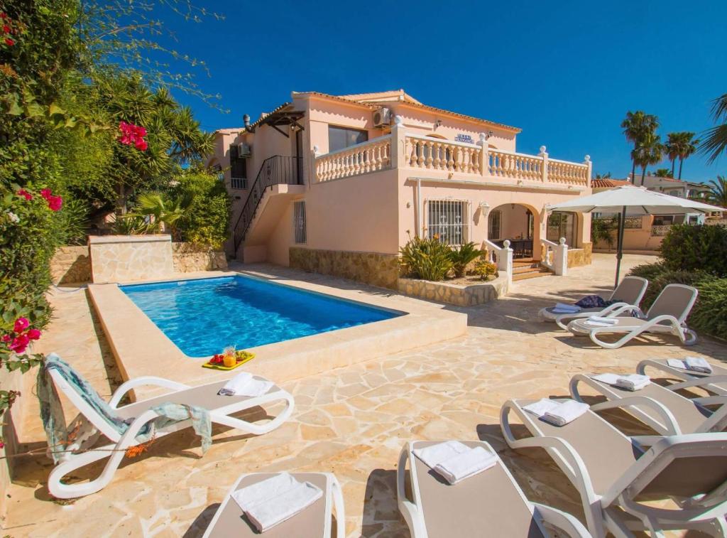 a villa with a swimming pool and a house at Villa Nerea - Plusholidays in Calpe
