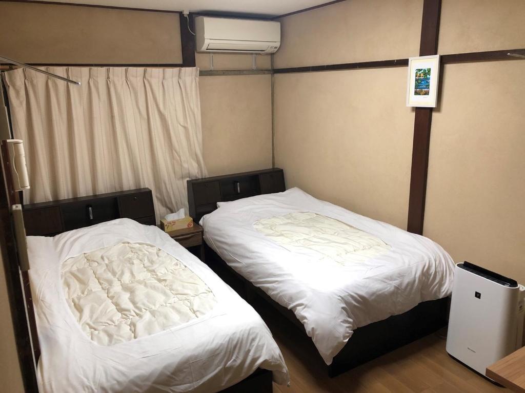 Postel nebo postele na pokoji v ubytování Guest House Ga-Jyun