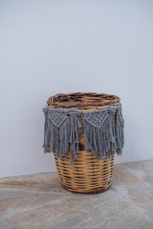 a wicker basket with a grey scarf on it at Gianemma Luxury Apartments in Mylopotas