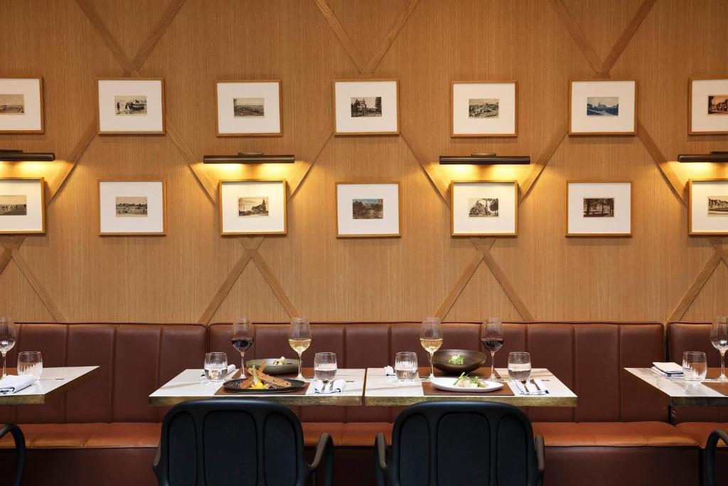 a restaurant with two tables with wine glasses at Hôtel Barrière Le Westminster in Le Touquet-Paris-Plage