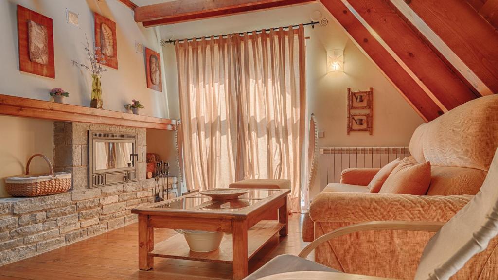a living room with a couch and a fireplace at Saplan Real Estate ERA LANA in Les