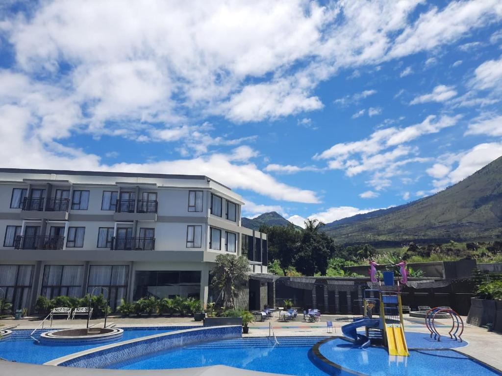 a large swimming pool with a blue sky at Harmoni Hotel Garut in Garut