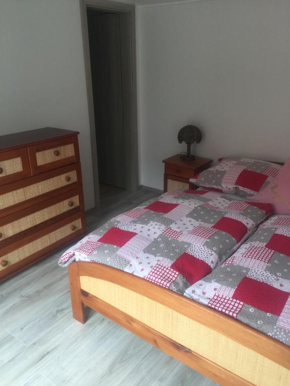 a bedroom with a bed and a dresser at Mobile House in Liptovský Trnovec