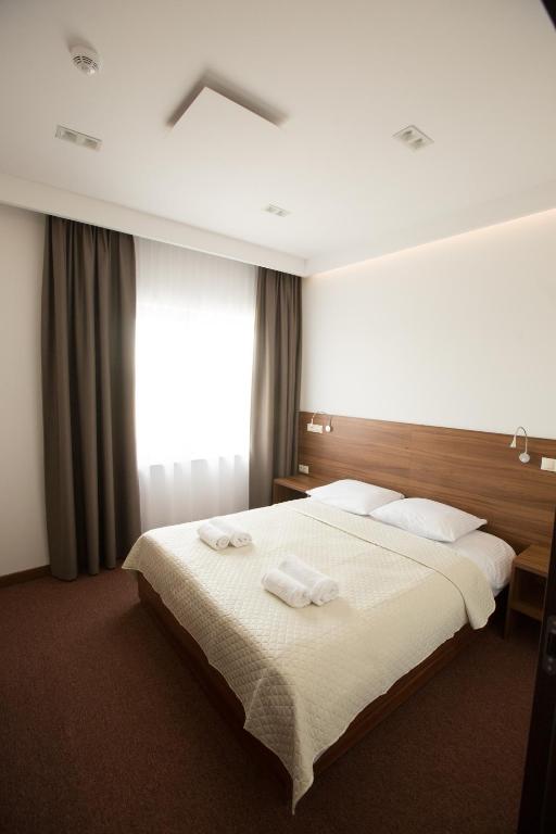 Postel nebo postele na pokoji v ubytování Hotel Rubin