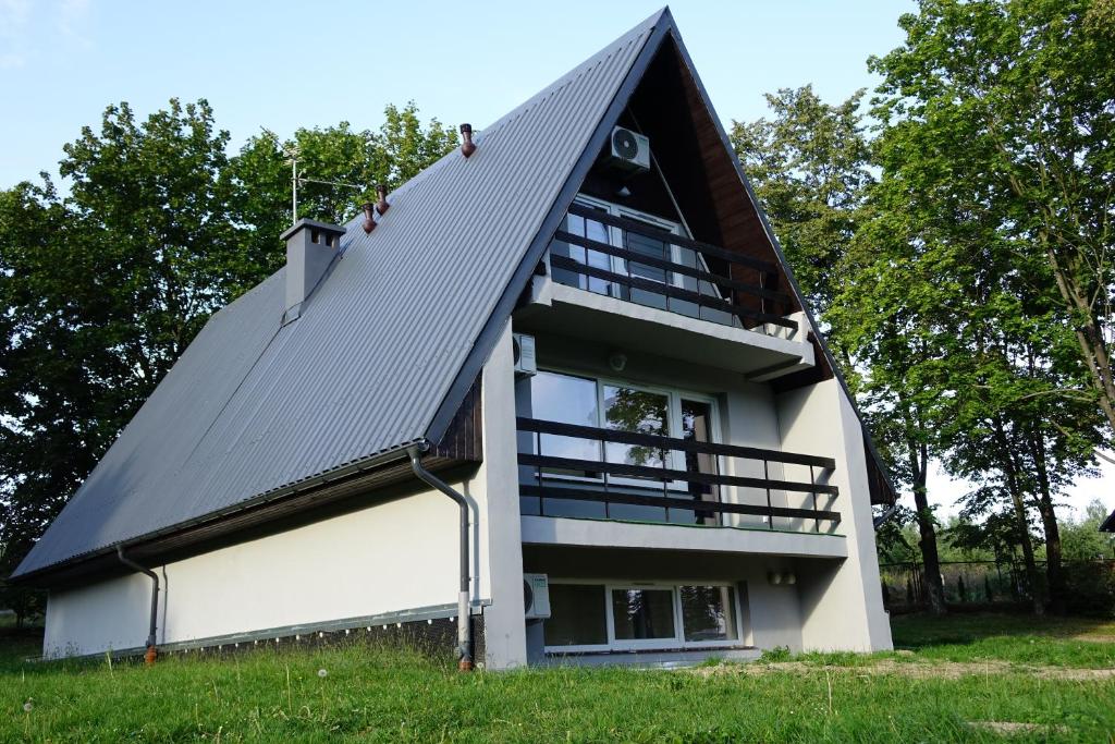 a house with a gambrel roof on top of it at Ośrodek Wypoczynkowy AKWA Marina in Nysa