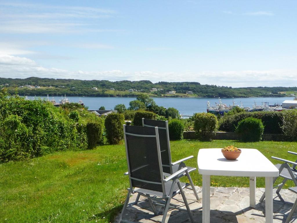 a table and chairs with a view of a lake at Atlantic View Holiday Home Killybegs in Killybegs