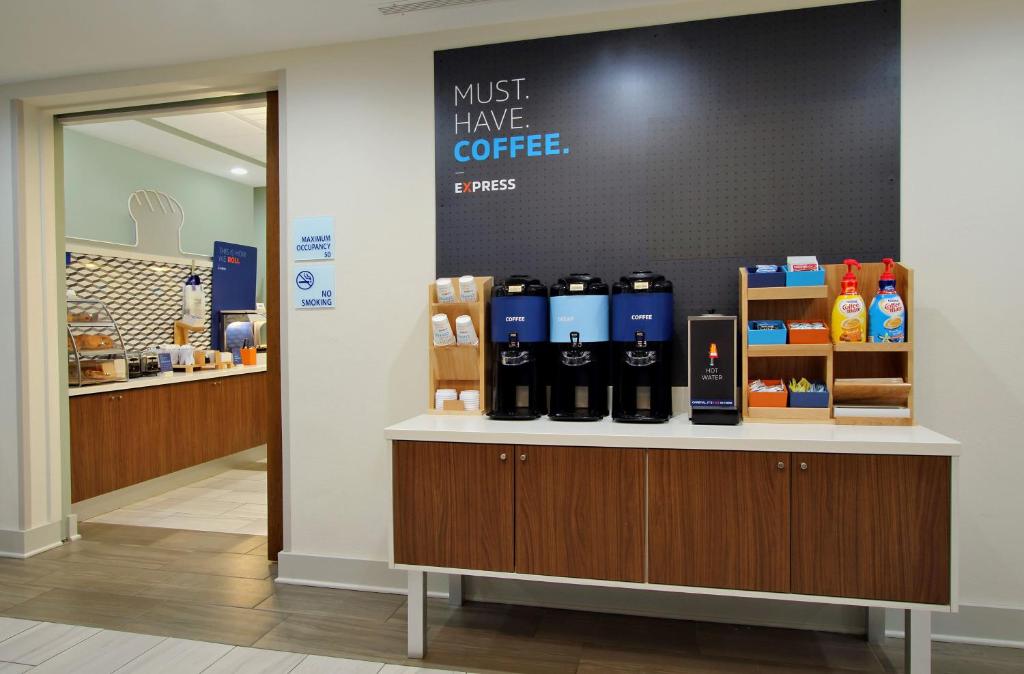 a coffee shop with a counter with bottles of coffee at Holiday Inn Express Wisconsin Dells, an IHG Hotel in Wisconsin Dells