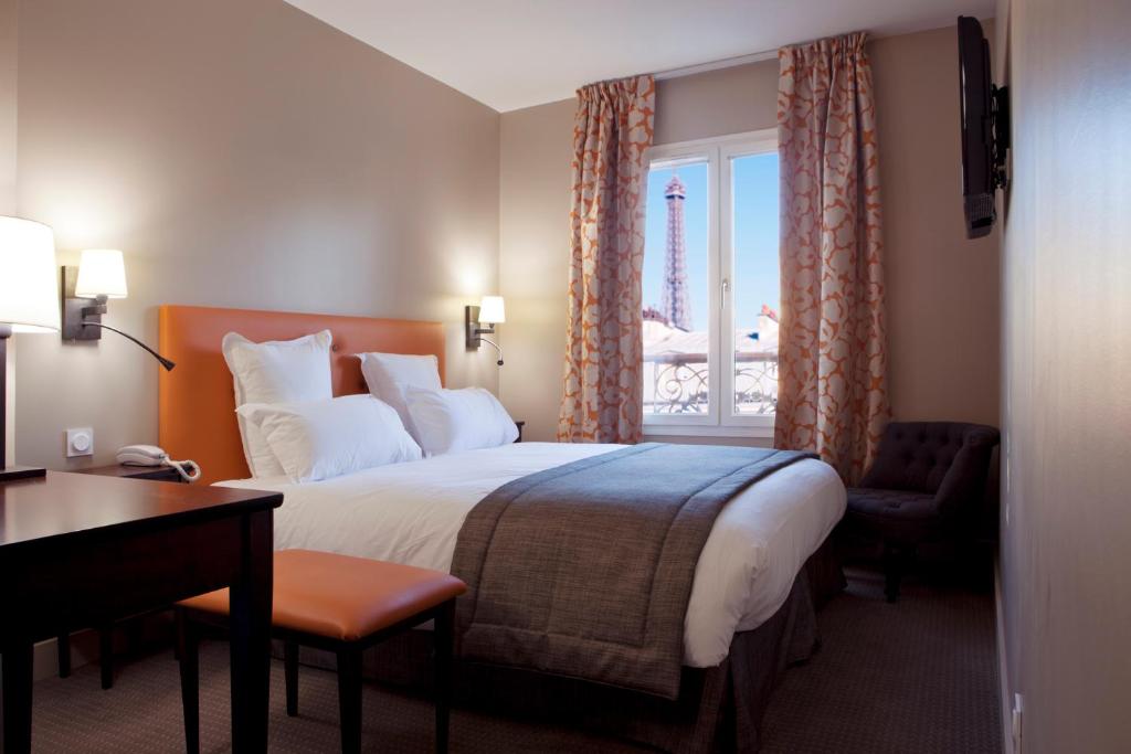 a hotel room with a bed and a window at Hôtel Le Relais Saint Charles in Paris