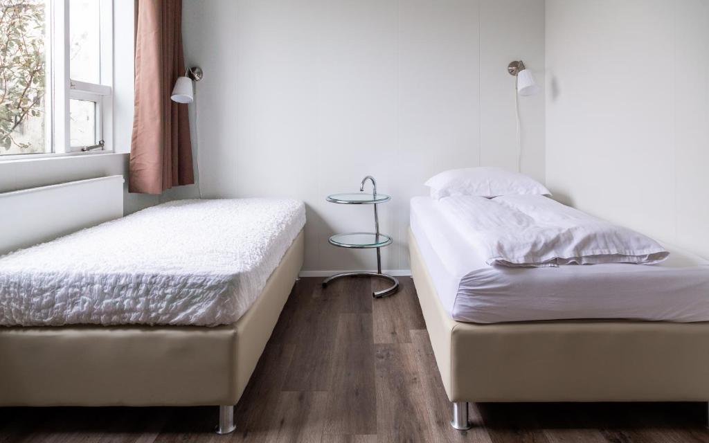 Postel nebo postele na pokoji v ubytování Guesthouse Hamar