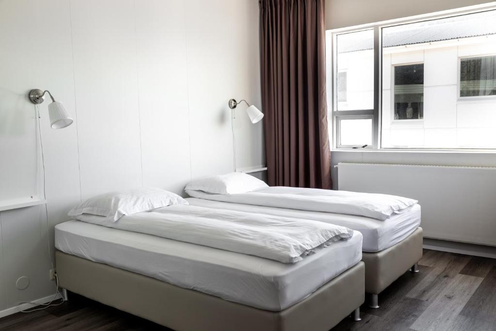 Postel nebo postele na pokoji v ubytování Guesthouse Hamar