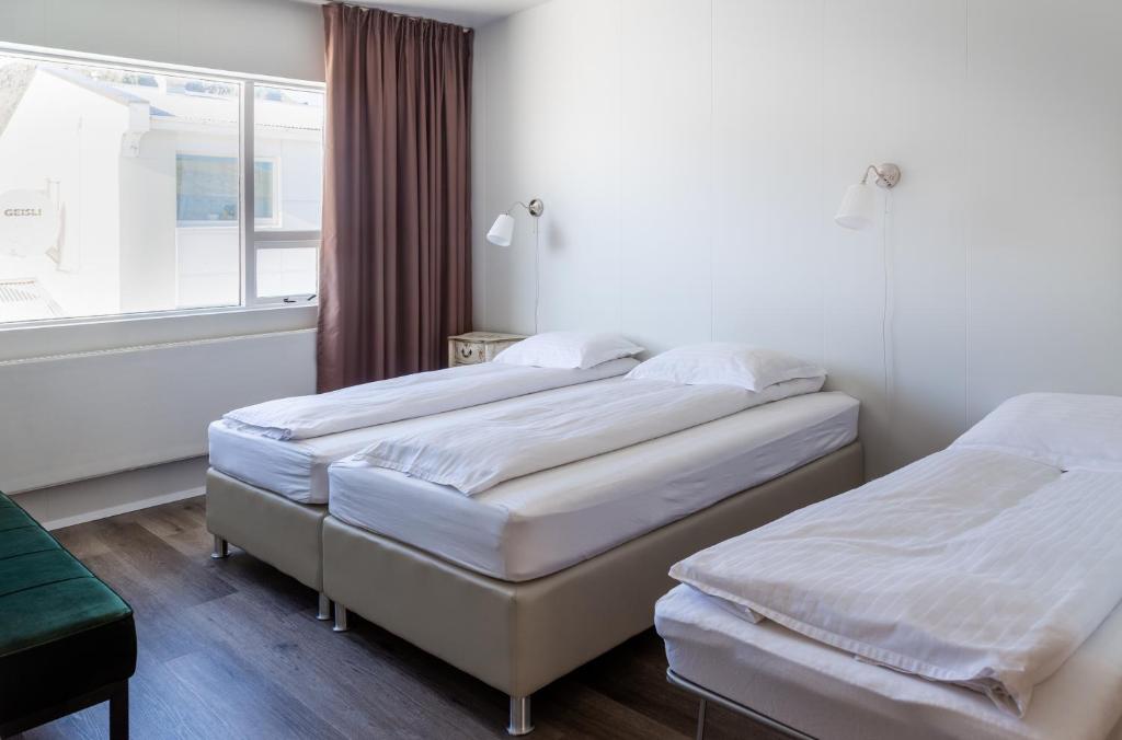 Postel nebo postele na pokoji v ubytování Guesthouse Hamar