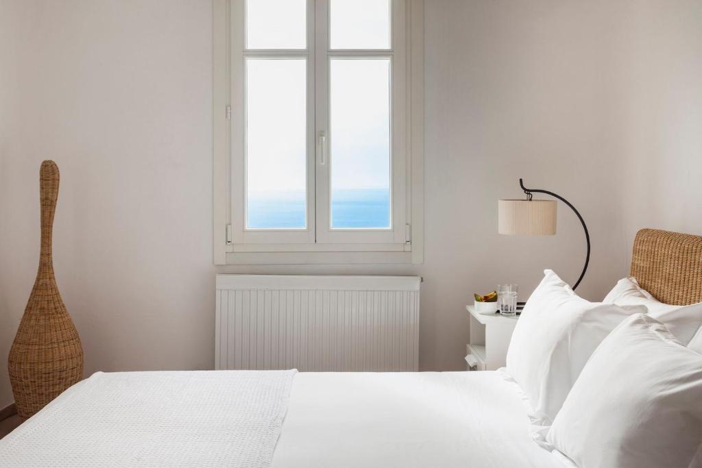 A bed or beds in a room at Agl Luxury Villas Mykonos Villa Apollonia