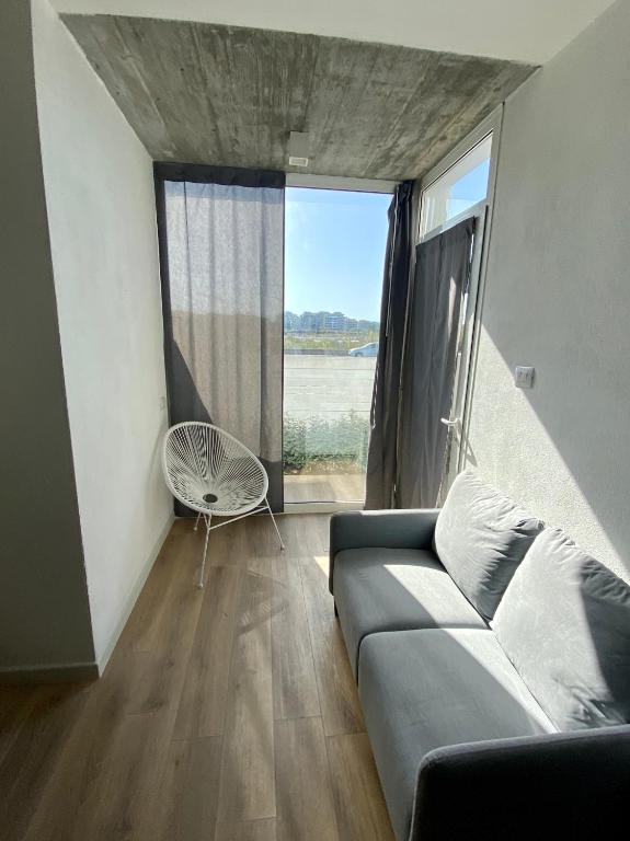 a living room with a couch and a large window at Residenza Acqva di Mare in Cagliari