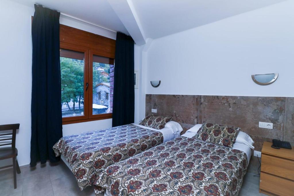 Postel nebo postele na pokoji v ubytování Hotel Comapedrosa