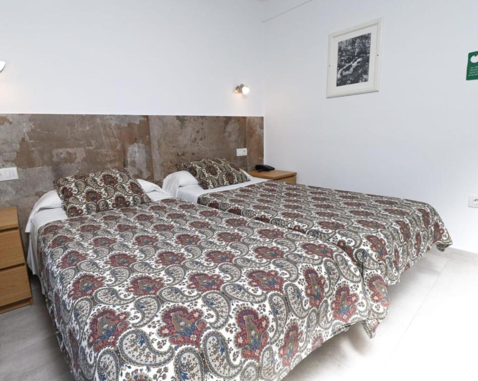 Postel nebo postele na pokoji v ubytování Hotel Comapedrosa