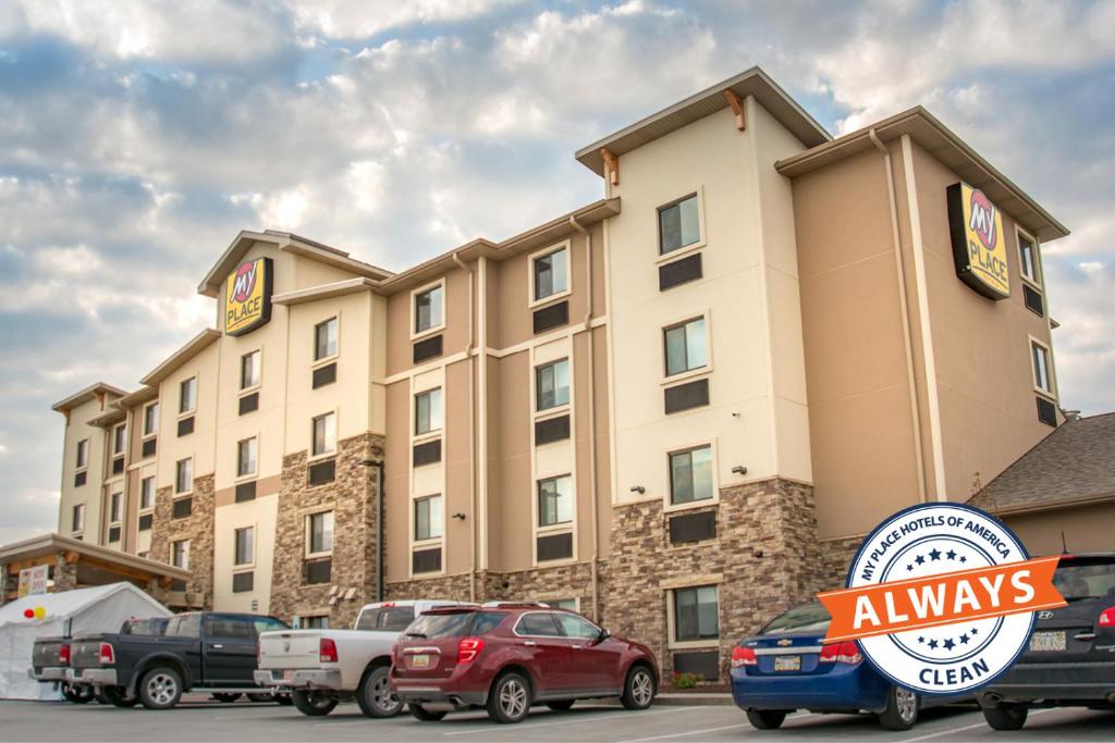 a hotel with cars parked in a parking lot at My Place Hotel-Council Bluffs/Omaha East, IA in Council Bluffs