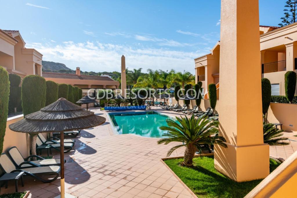 a villa with a swimming pool in a resort at Baia da Luz Resort in Luz