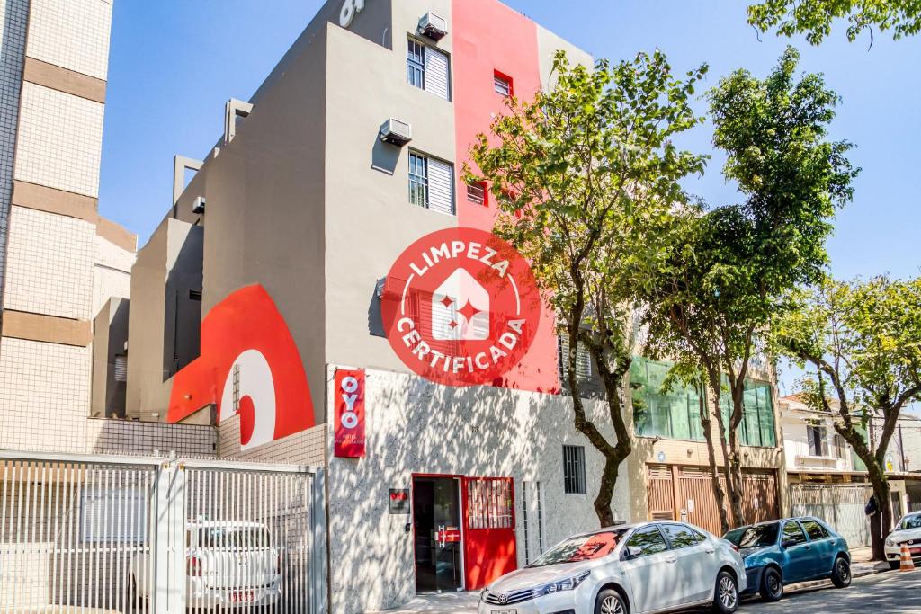 a building with a red sign on the side of it at HOTEL PAULISTANO Center Norte in São Paulo