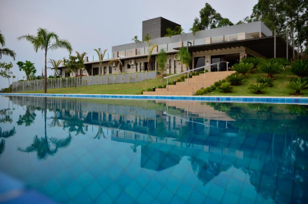 a swimming pool in front of a building at Capão do Cerrado Pousada e Spa in Itabirito