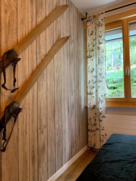 a bedroom with a wooden wall with two wooden axes at Verbier Medran apartment in Verbier