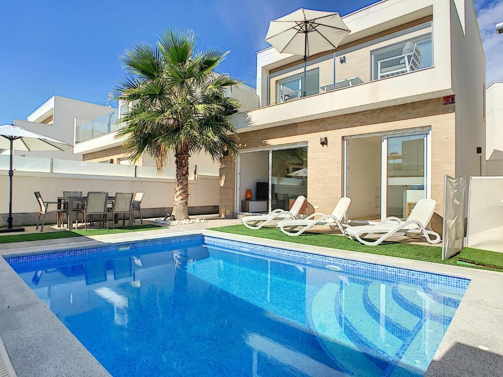 a villa with a swimming pool in front of a house at Villa Sol - San Pedro del Pinatar - 1710 in San Pedro del Pinatar