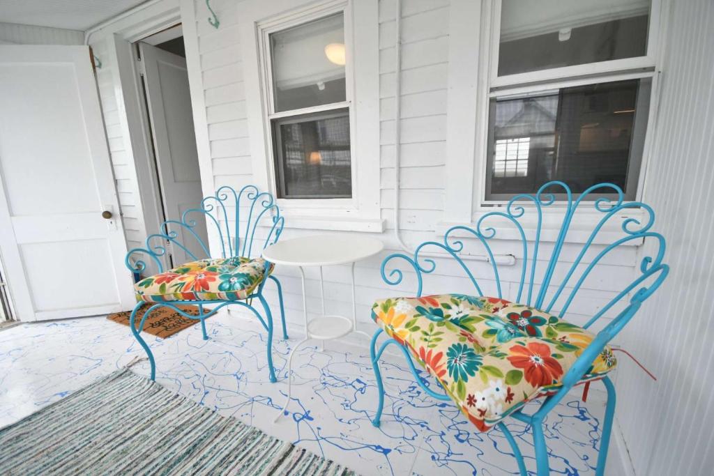 two blue chairs and a table on a porch at Baby Love Shack in Salisbury