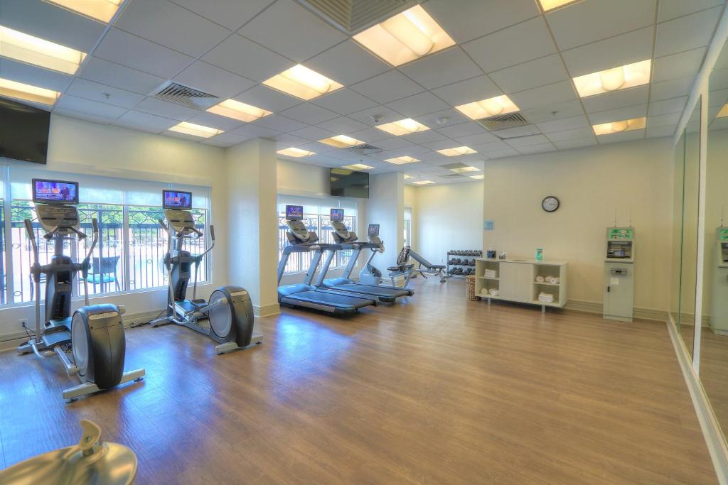 a gym with treadmills and ellipticals in a room at Holiday Inn Express Hotel & Suites Mobile Saraland by IHG in Saraland